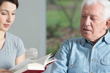 Horizon Live-in carer reads to elderly man